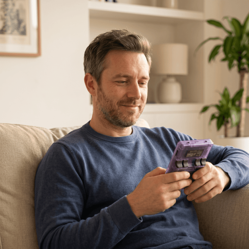 Person playing the Ausbs Pro 2.0 R36S retro gaming console at home
